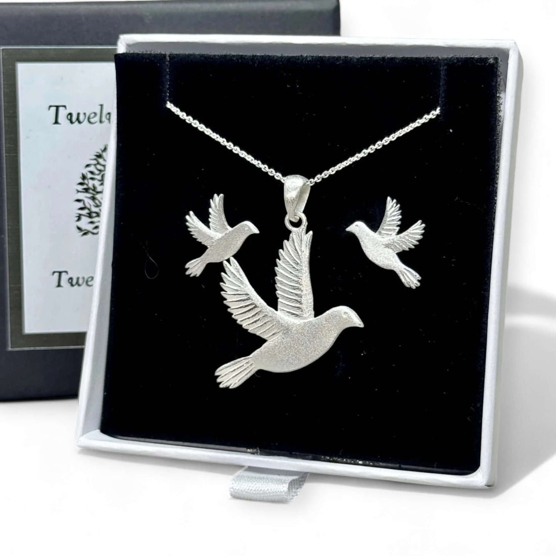 Image of handmade sterling silver dove of peace earrings & pendant in a black and white Twelve Silver Trees Jewellery and gifts signature gift box 