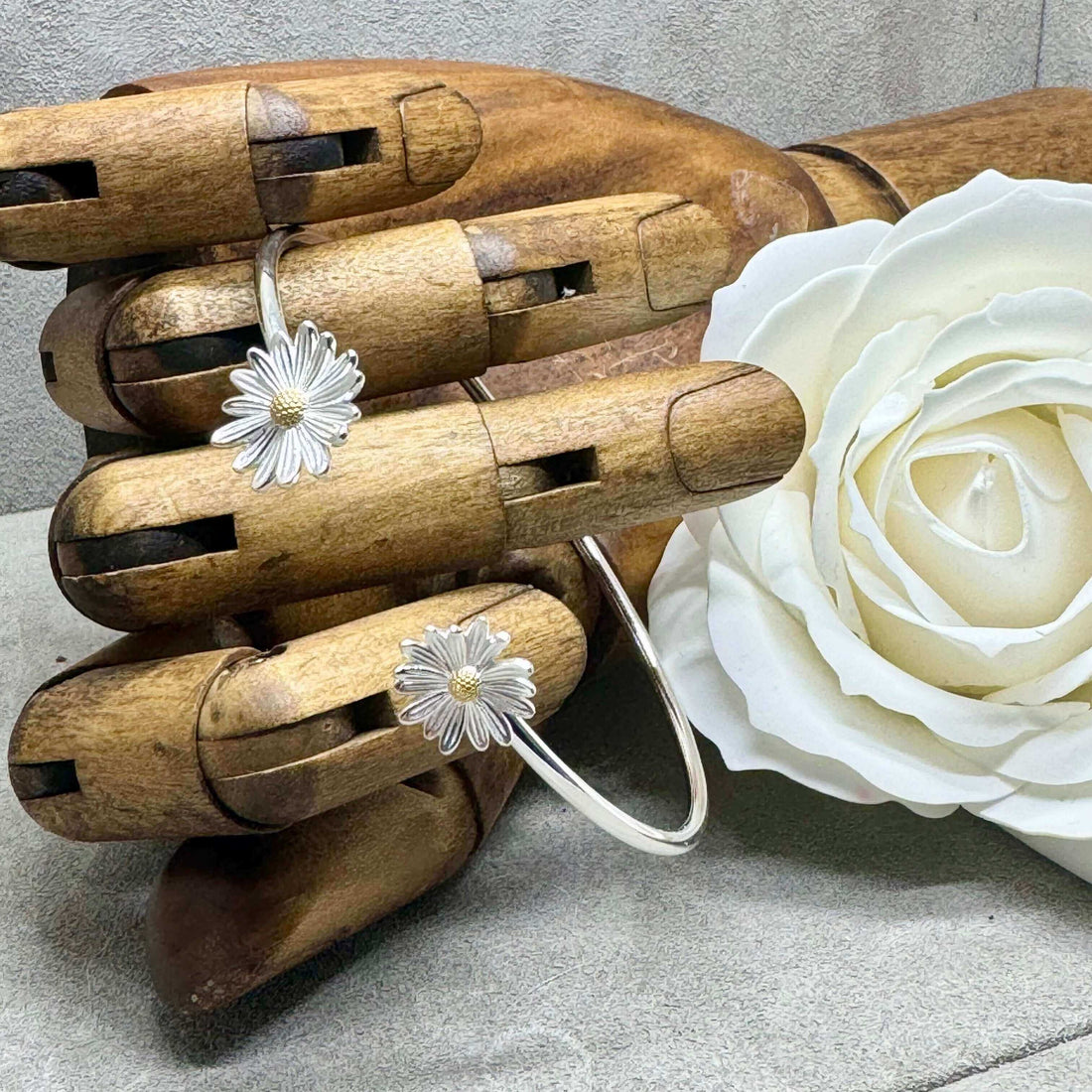 Handmade sterling silver flower cuff bangle featuring 2 asymmetrical daisys from the Daisy collection at twelve silver trees jewellery