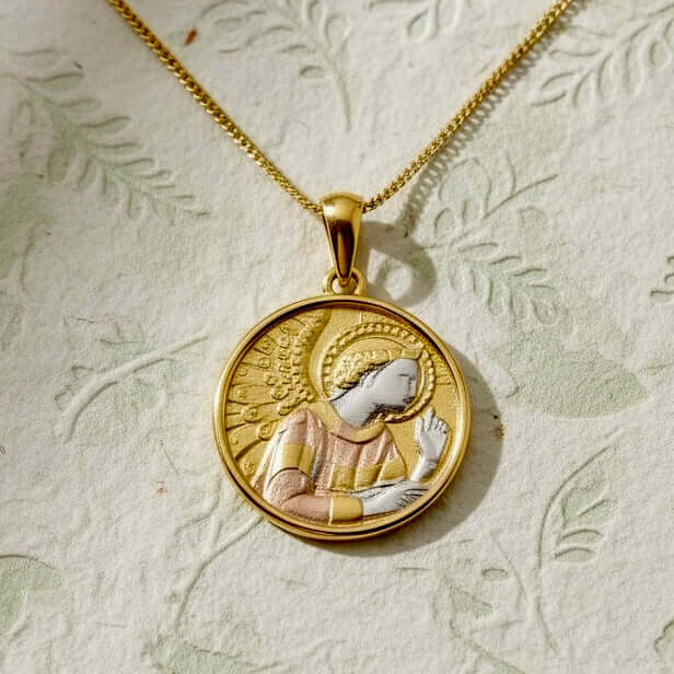 Artisan sterling silver pendant of the Archangel Gabriel, a symbol of guidance and deliverance, finish in rhodium, rose and yellow gold on a flowal background from Twelve Silver Trees Jewellery and Gifts