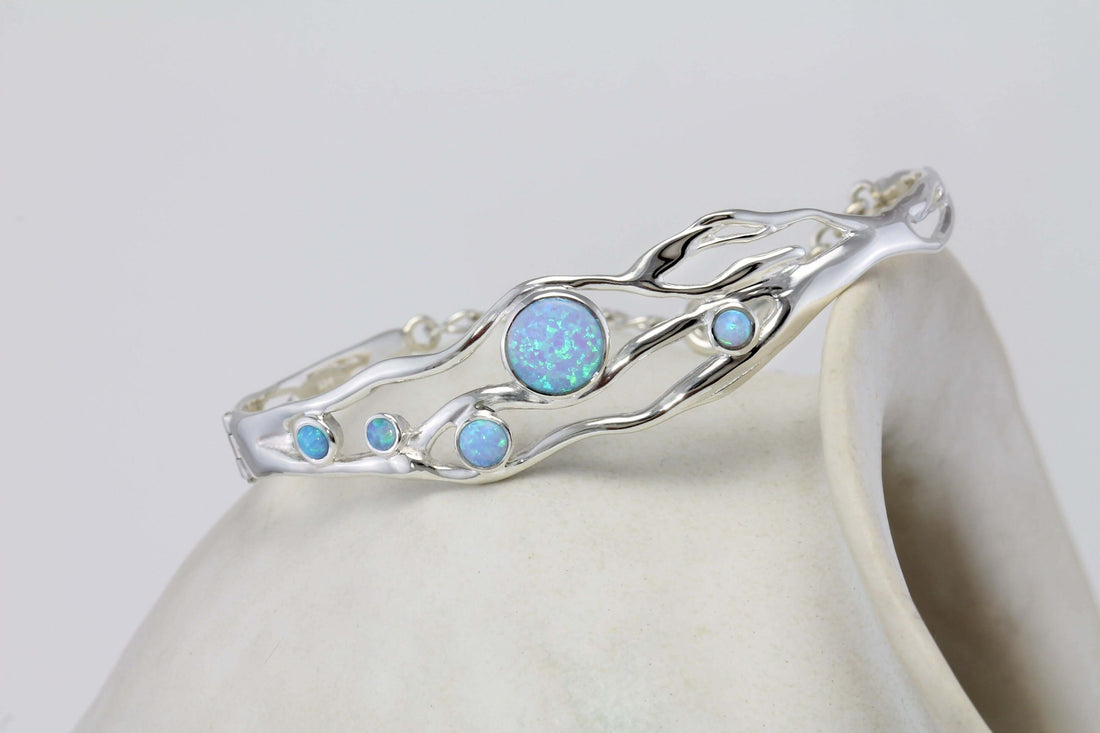 Cover image The Advantages Of Lab Created Opals featuring a handmade sterling silver bangle from Twelve Silver Trees Jewellery & Gifts 