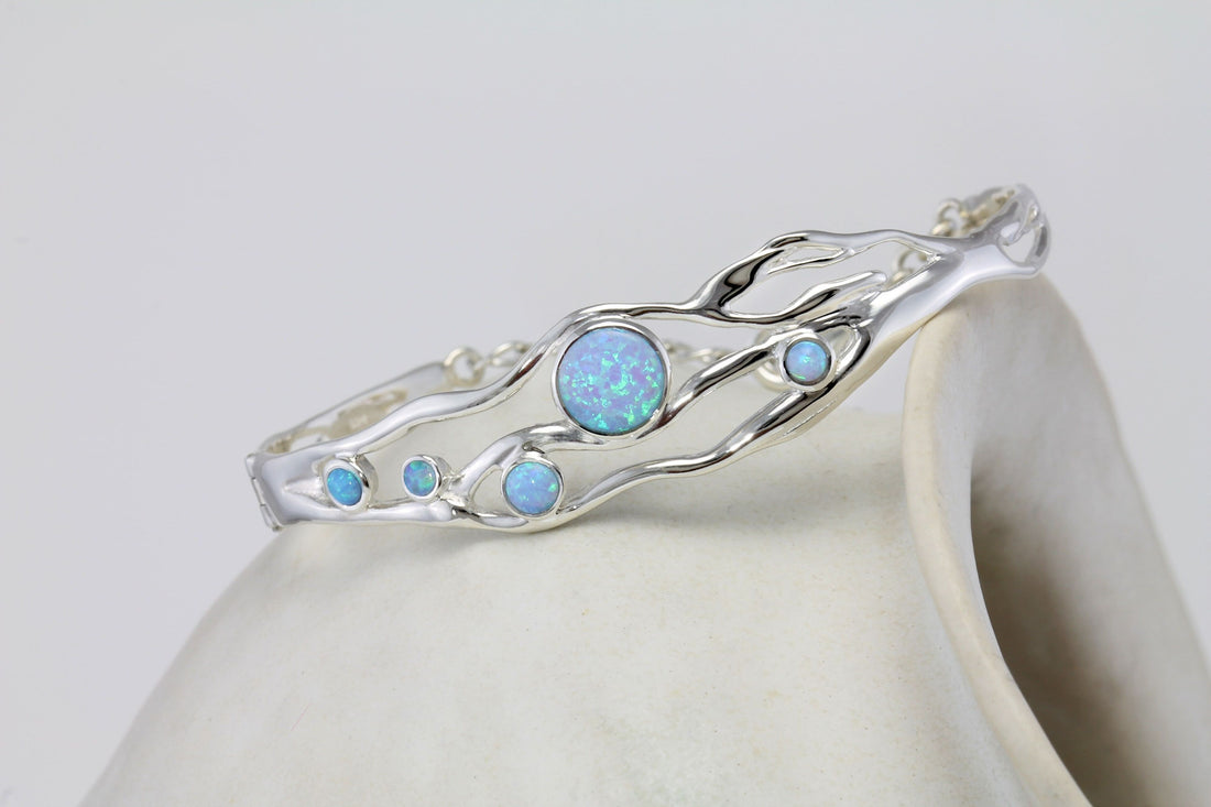 Cover image The Advantages Of Lab Created Opals featuring a handmade sterling silver bangle from Twelve Silver Trees Jewellery & Gifts 