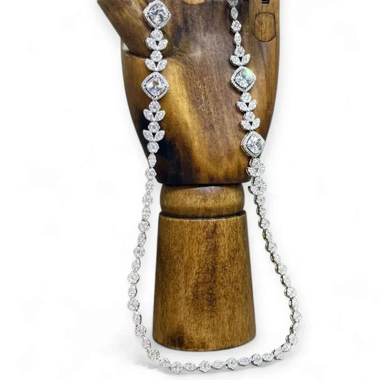 Image of Twelve Silver Trees Jewellery handmade sterling silver Art Deco Styled necklace displayed on a dark wooden artists model hand on a white background 