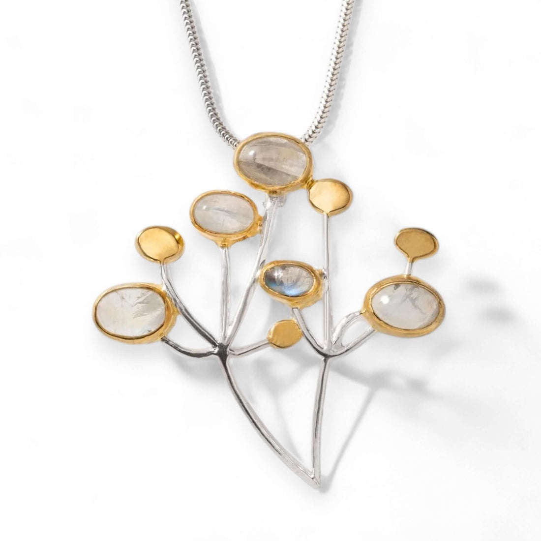 Handmade sterling silver pendant set with rainbow moonstones and 18 carat gold accents of a cow parsley wildflower. Pictured on a white background available from Twelve Silver Trees Jewellery and Gifts