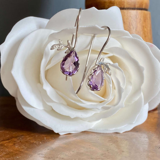 Handmade sterling silver hook earrings featuring, each with a vibrant amethyst pear cut gemstone with leaf details, part of our February’s Amethyst birthstone jewellery collection at Twelve Silver Trees Jewellery and Gifts