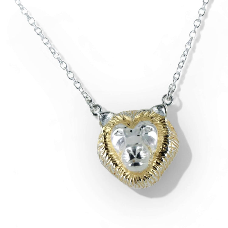 Image of a sterling silver lion head pendant finished with 18 carat gold accents 