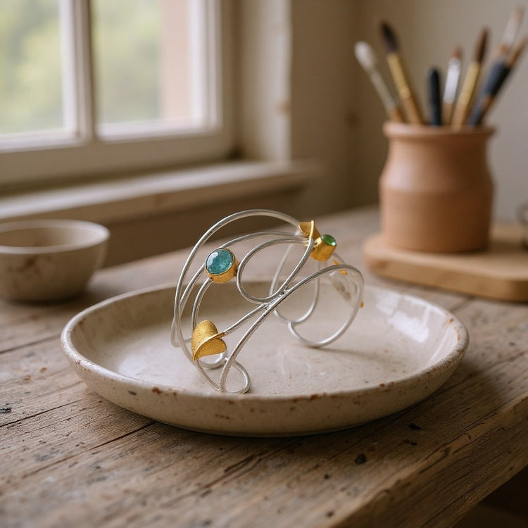Image of an art nouveau bangle set in sterling silver with natural gemstones based on designs by Margret Macdonald 