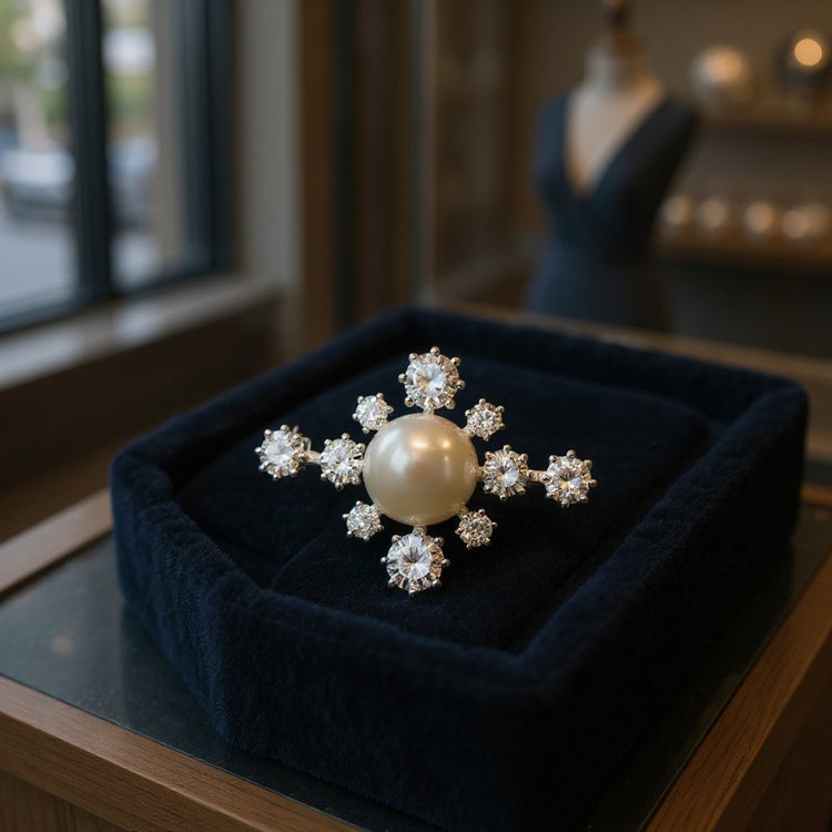 Image of sterling silver starburst brooch set with a freshwater Pearl 