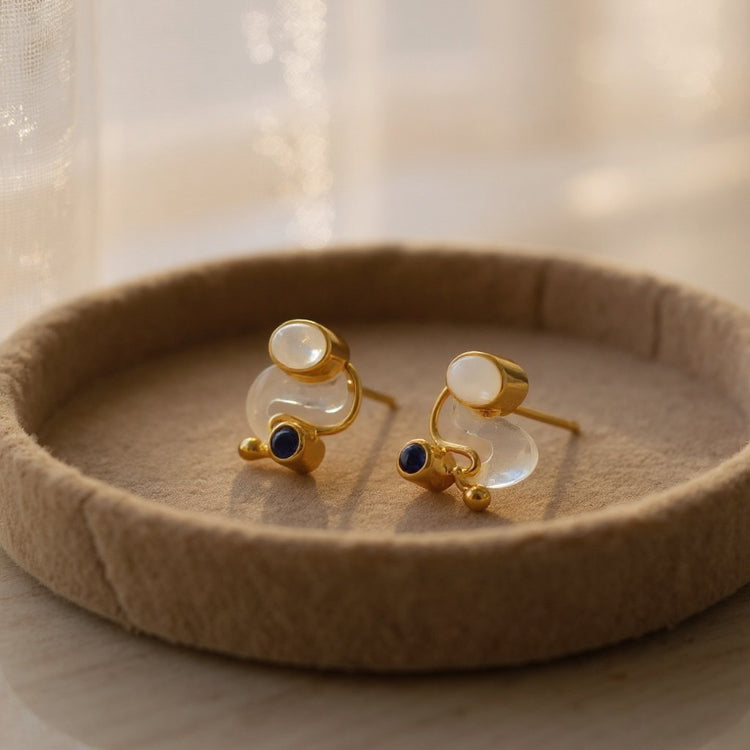 Handmade sterling silver stud earrings with rainbow moonstone & 18 carat gold accents dudpksyed in a handmade wooden trinket dish 
