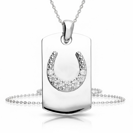 A silver Dog Tag style pendant in sterling silver with a raised cubic zirconia studded horseshoe from the Equestrian Collection at Twelve Silver Trees Jewellery displayed on a white background 