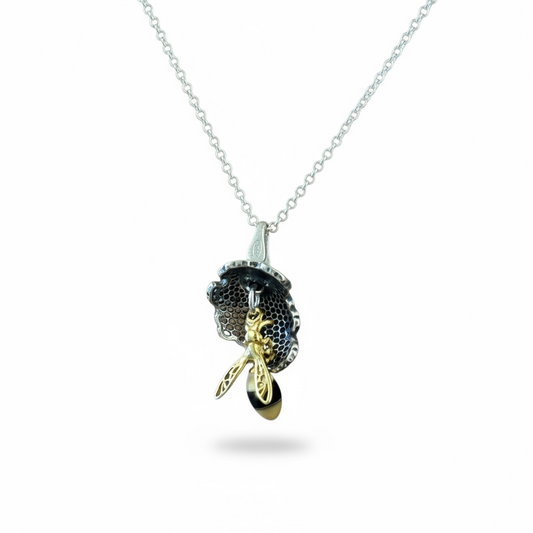 Handmade sterling silver bee pendant with baltic Amber bodies and gold plated wings suspended from concave honeycomb in pierced silver from the bee collection at Twelve Silver Trees Jewellery 