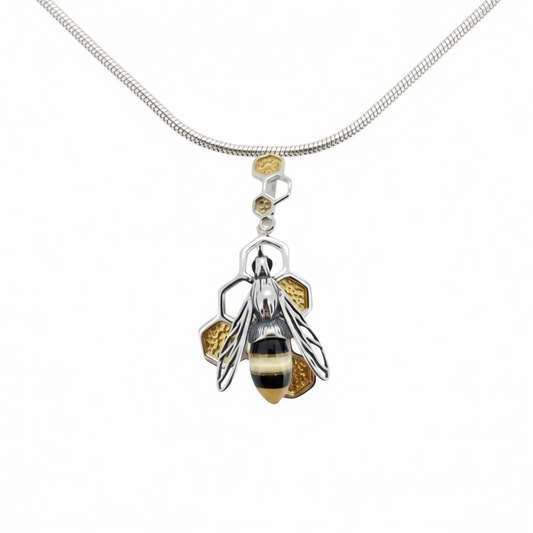 Handmade sterling silver bee pendant with baltic Amber set on gold plated  honeycomb in pierced silver from the bee collection at Twelve Silver Trees Jewellery 