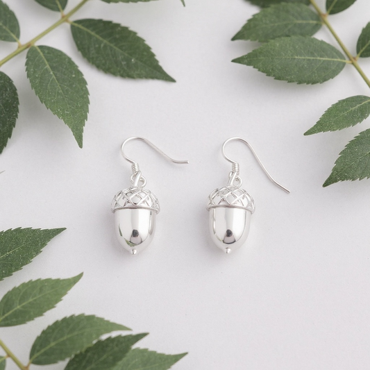 Sterling Silver acorn-shaped hook earrings on a white background with leaves from The Herbarium Collection at Twelve Silver Trees Jewellery and Gifts 