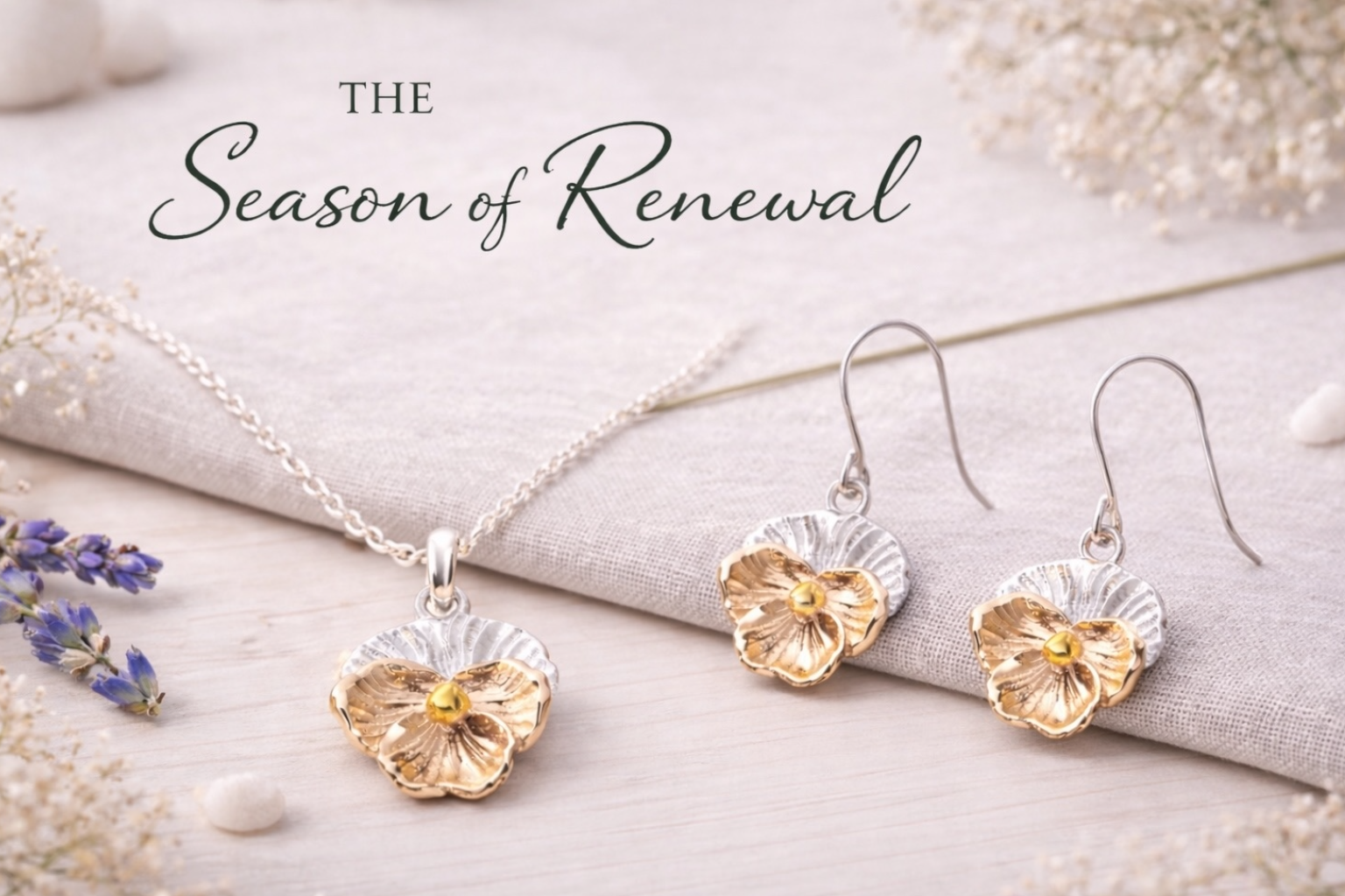 Silver Gold violet flower-shaped earrings and pendant jewellery set with 'The Season of Renewal' text on a light background.