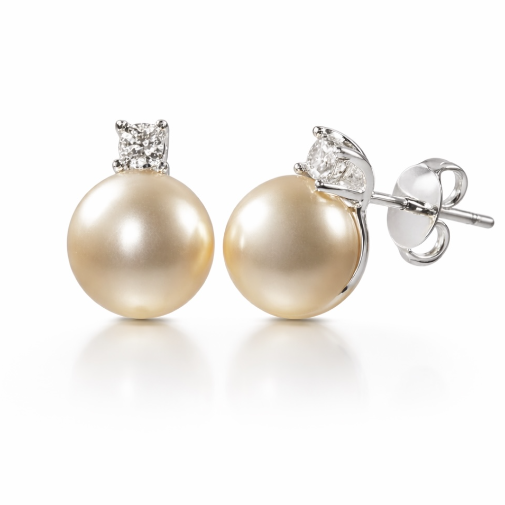 Pair of pearl earrings with diamond accents on a white background