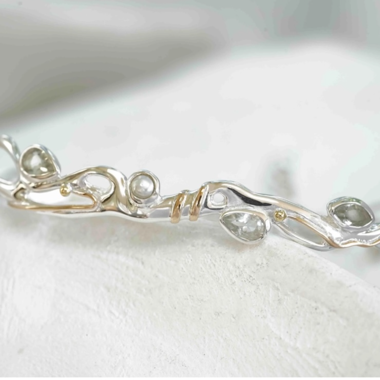 Close up of green amethyst and pearl bracelet with gold accents in sterling silver, sculptural Sunlit Earth design