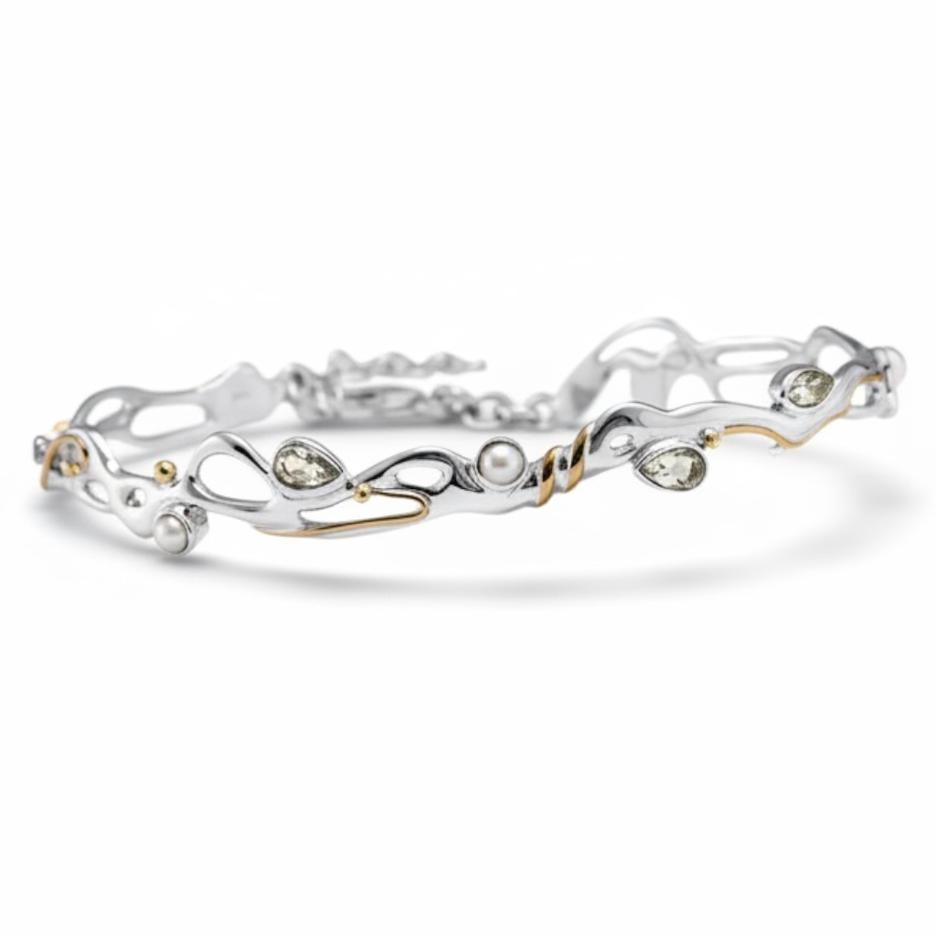 Green amethyst and pearl sculptural bracelet in sterling silver with gold accents on white background