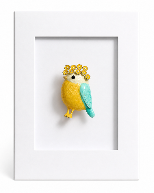Charming bird keepsake card featuring a yellow and blue bird brooch with floral crown mounted within a white presentation card.