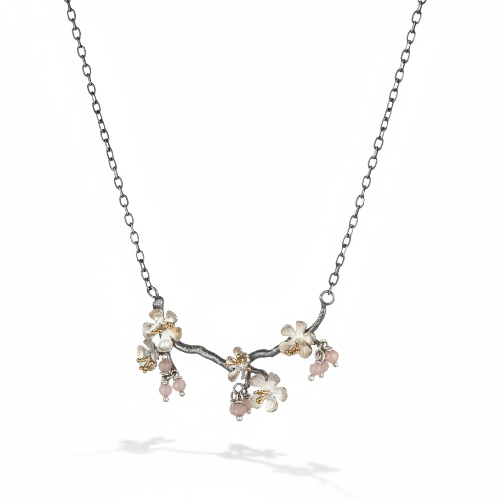 Almond Blossom branch necklace in sterling silver with blossom flowers and pink gemstone accents