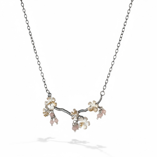 Almond Blossom branch necklace in sterling silver with blossom flowers and pink gemstone accents