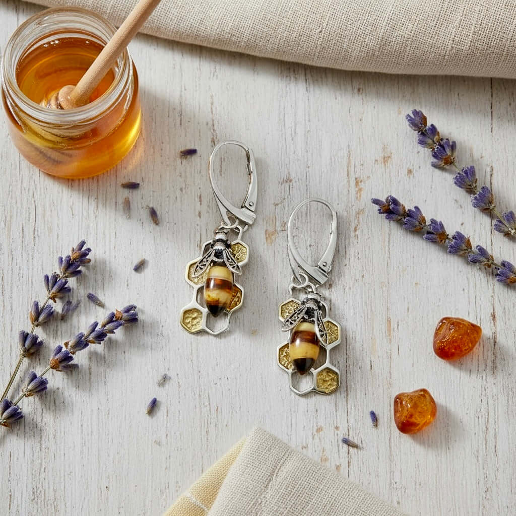 Baltic amber bee earrings styled with lavender and honey on a natural - Twelve Silver Trees