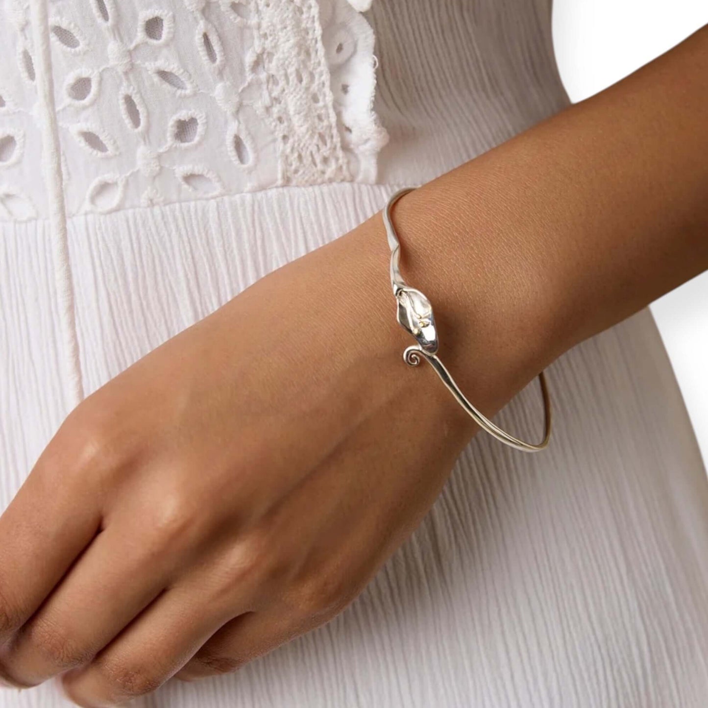 Model wearing  handcrafted Calla Lily floral bangle in sterling silver with gold detailing- Twelve Silver Trees