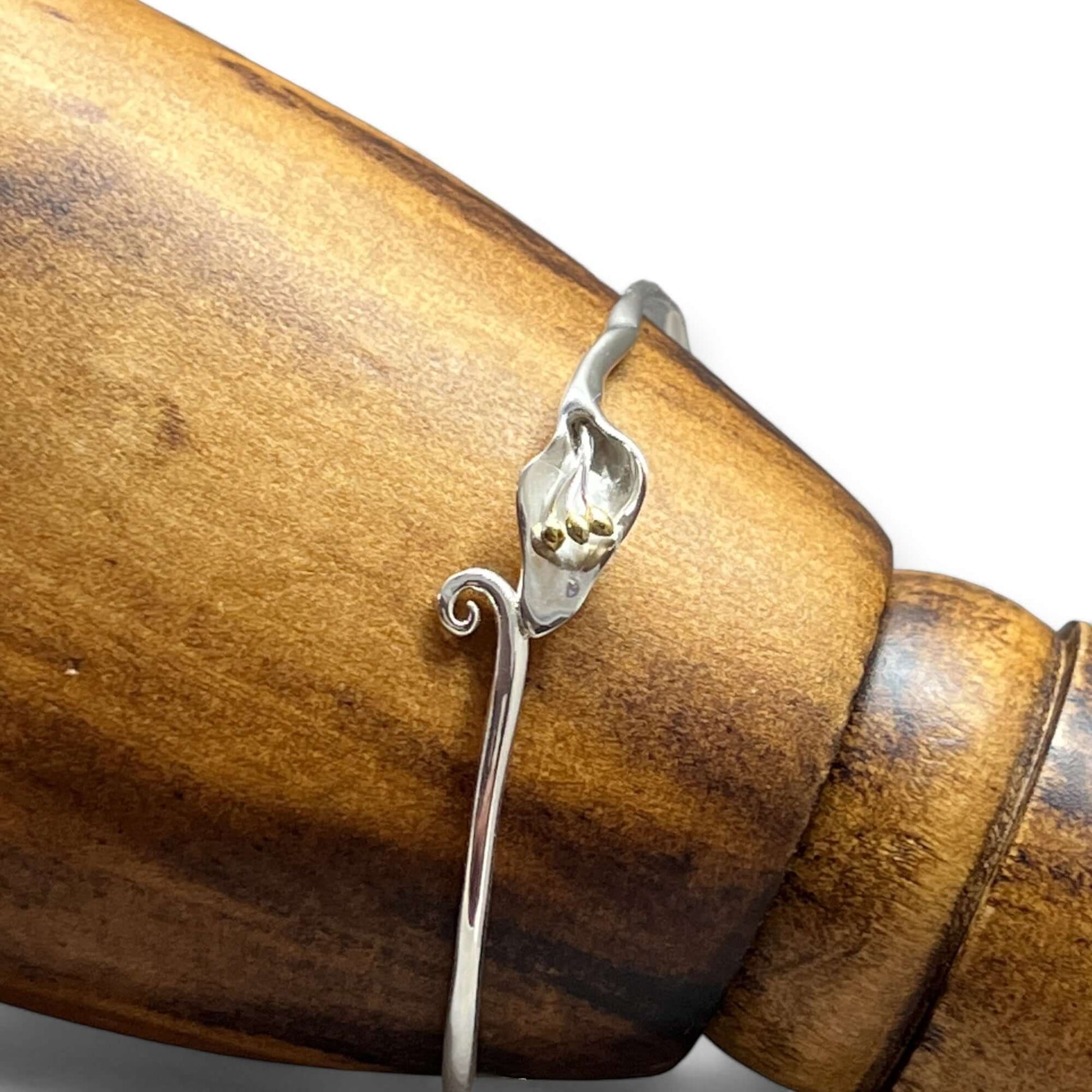 Front view of handcrafted Calla Lily floral bangle in sterling silver with gold detailing - Twelve Silver Trees