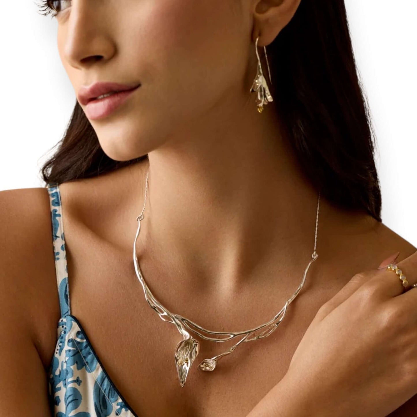 Model wearing Calla Lily sculptural sterling silver statement necklace with gold detail - Twelve Silver Trees