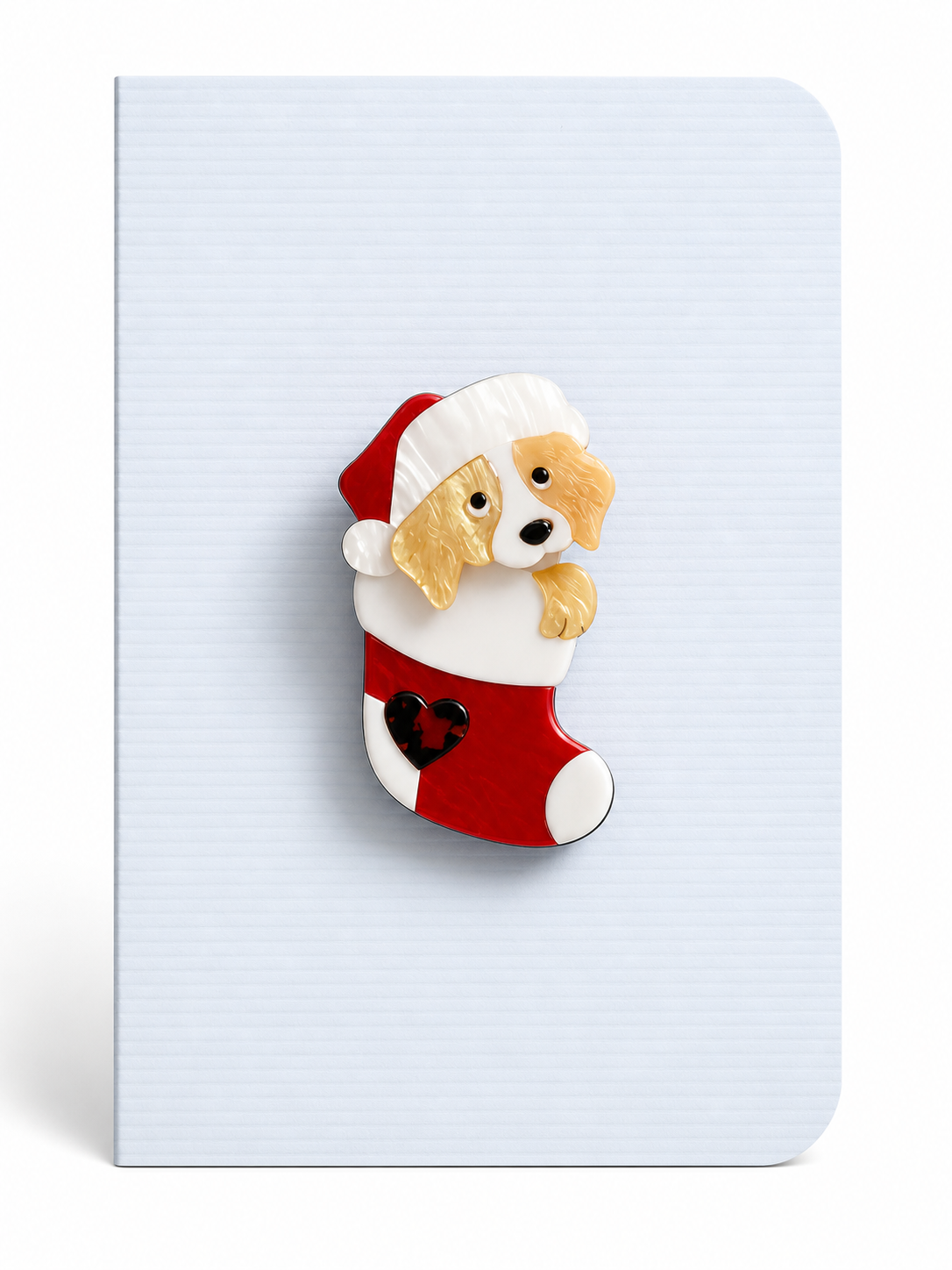 Christmas keepsake card featuring a festive puppy in a stocking brooch mounted on a white textured greeting card.
