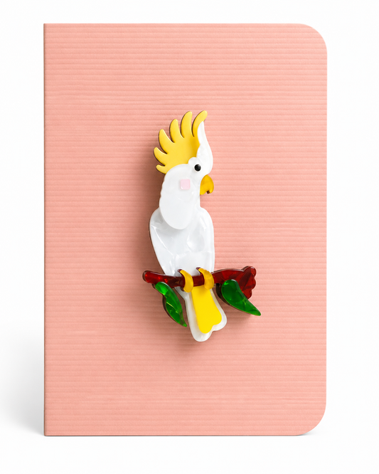 Colourful cockatoo keepsake card featuring a detailed tropical bird brooch perched on a branch, mounted on a textured greeting card.