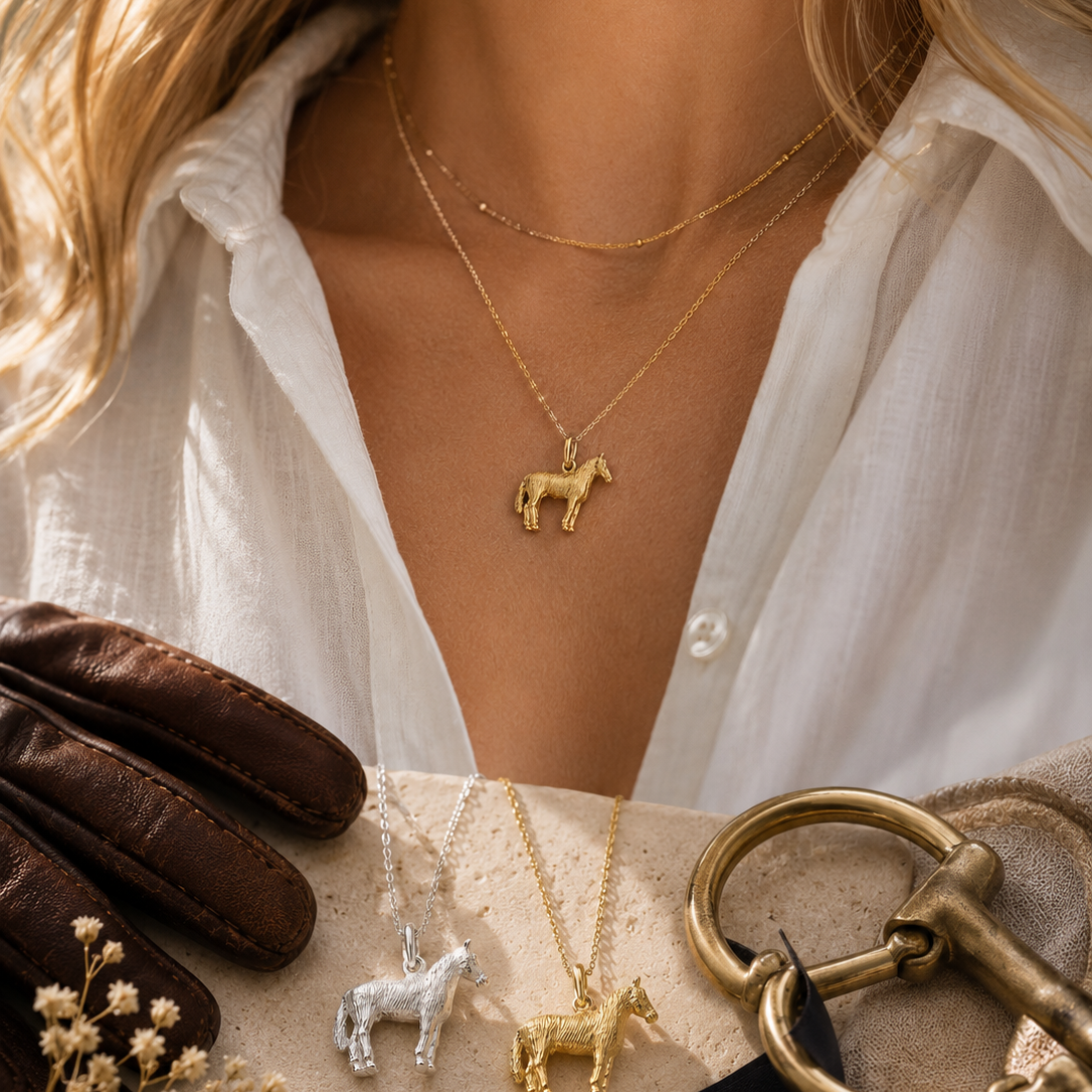 Editorial equestrian styling featuring sterling silver and gold vermeil horse pendant necklaces with luxury riding-inspired details