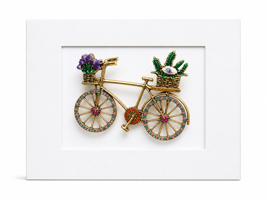 Keepsake brooch card featuring a decorative bicycle brooch with flower baskets and crystal wheels on a white display card