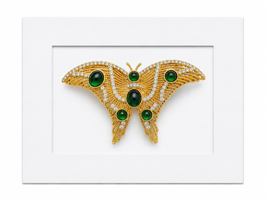 Keepsake brooch card featuring a gold butterfly brooch with green gemstones and crystal detailing on a white display card