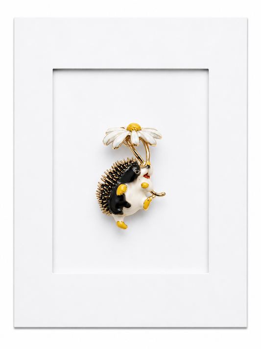 Keepsake brooch card featuring a whimsical hedgehog brooch holding a daisy flower on a white display card
