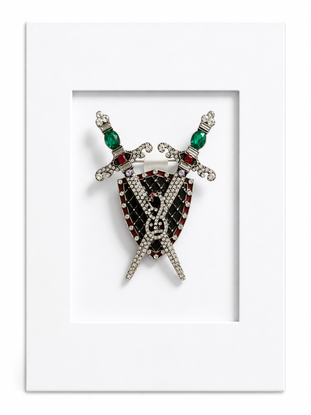 Statement keepsake card featuring a heraldic shield and crossed swords brooch mounted within a white presentation card.