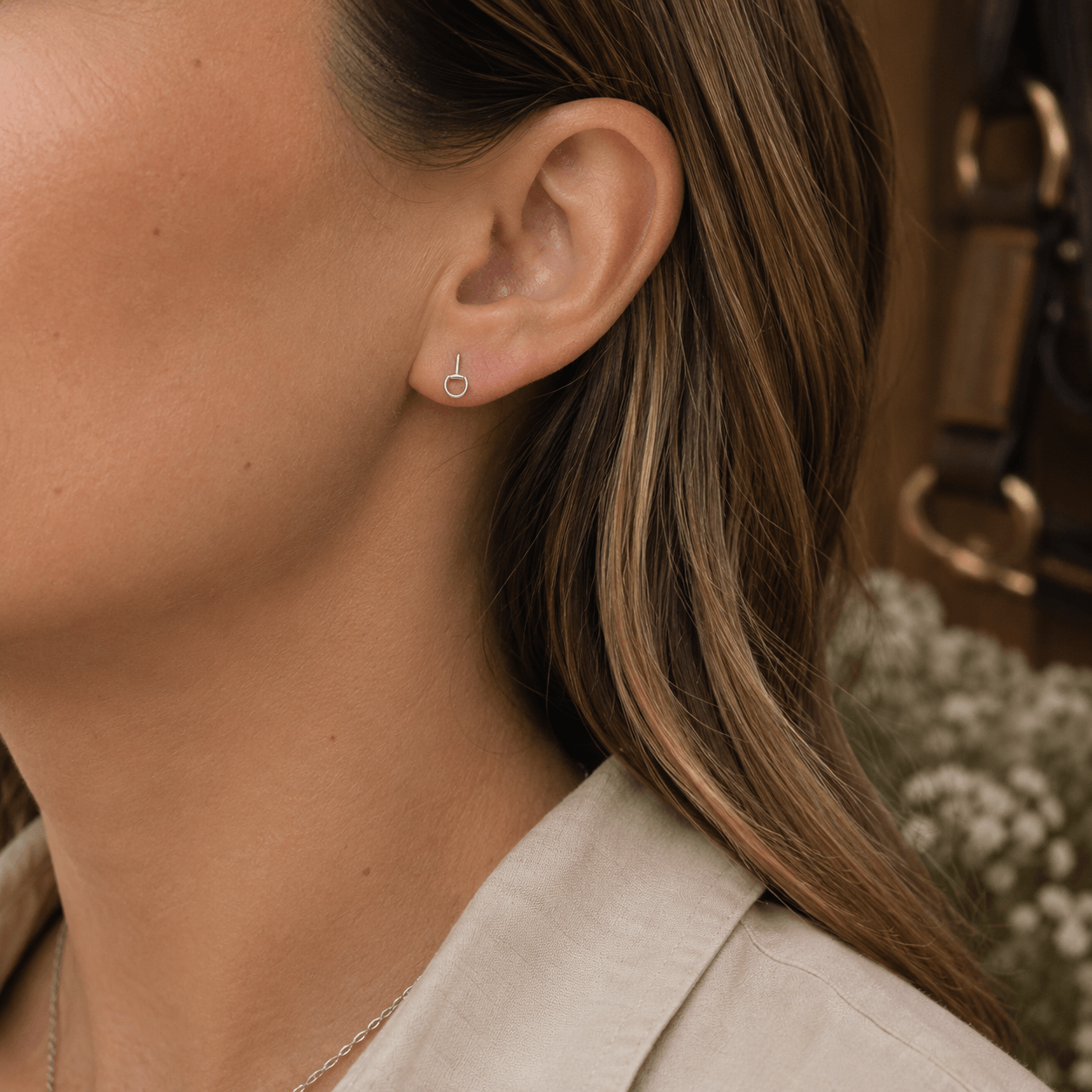 Mini sterling silver snaffle stud earrings being worn, showing delicate equestrian-inspired everyday styling