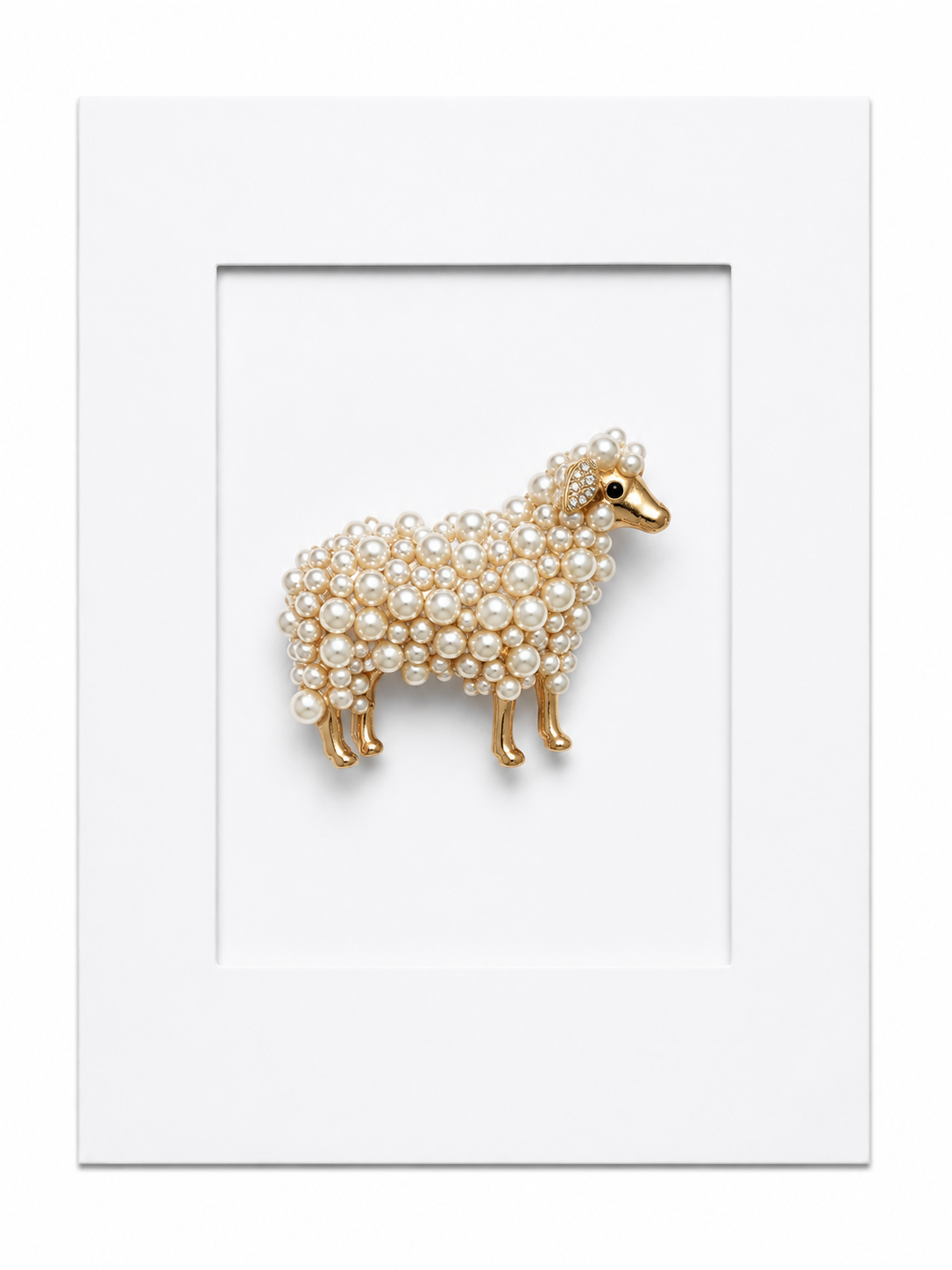 Keepsake brooch card featuring a pearl embellished sheep brooch with gold detailing on a white display card
