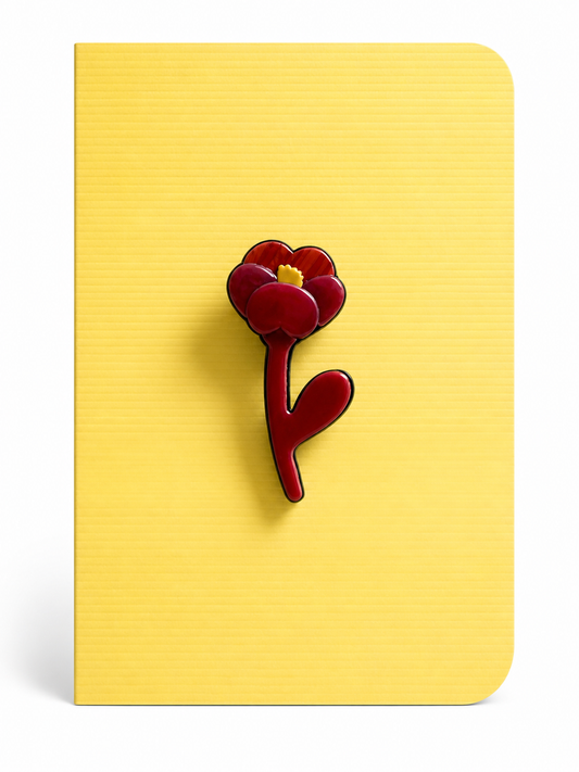 Handmade poppy flower keepsake card featuring a bold red flower brooch mounted on a soft yellow textured greeting card.