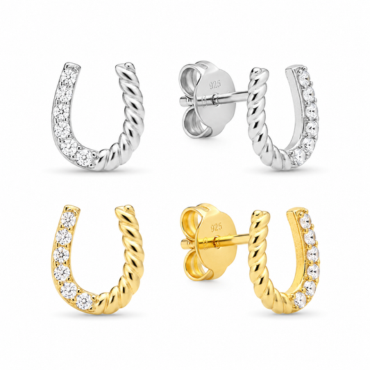 Sterling silver and gold vermeil horseshoe stud earrings with cubic zirconia on a white background