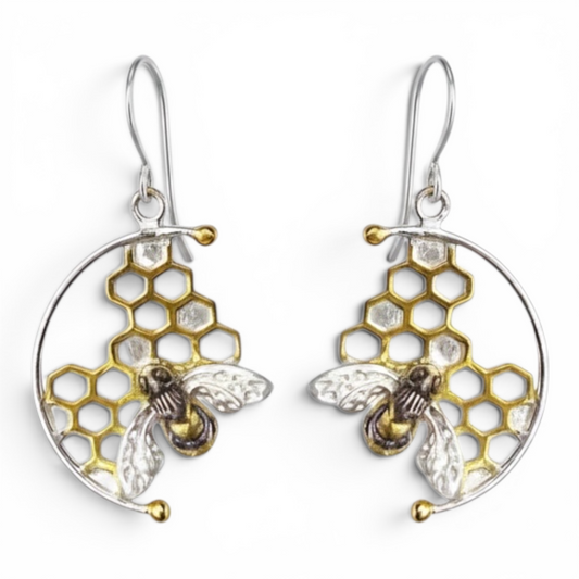 Handmade sterling silver honeycomb bee hook earrings with 22ct gold vermeil honeycomb details on a white background.