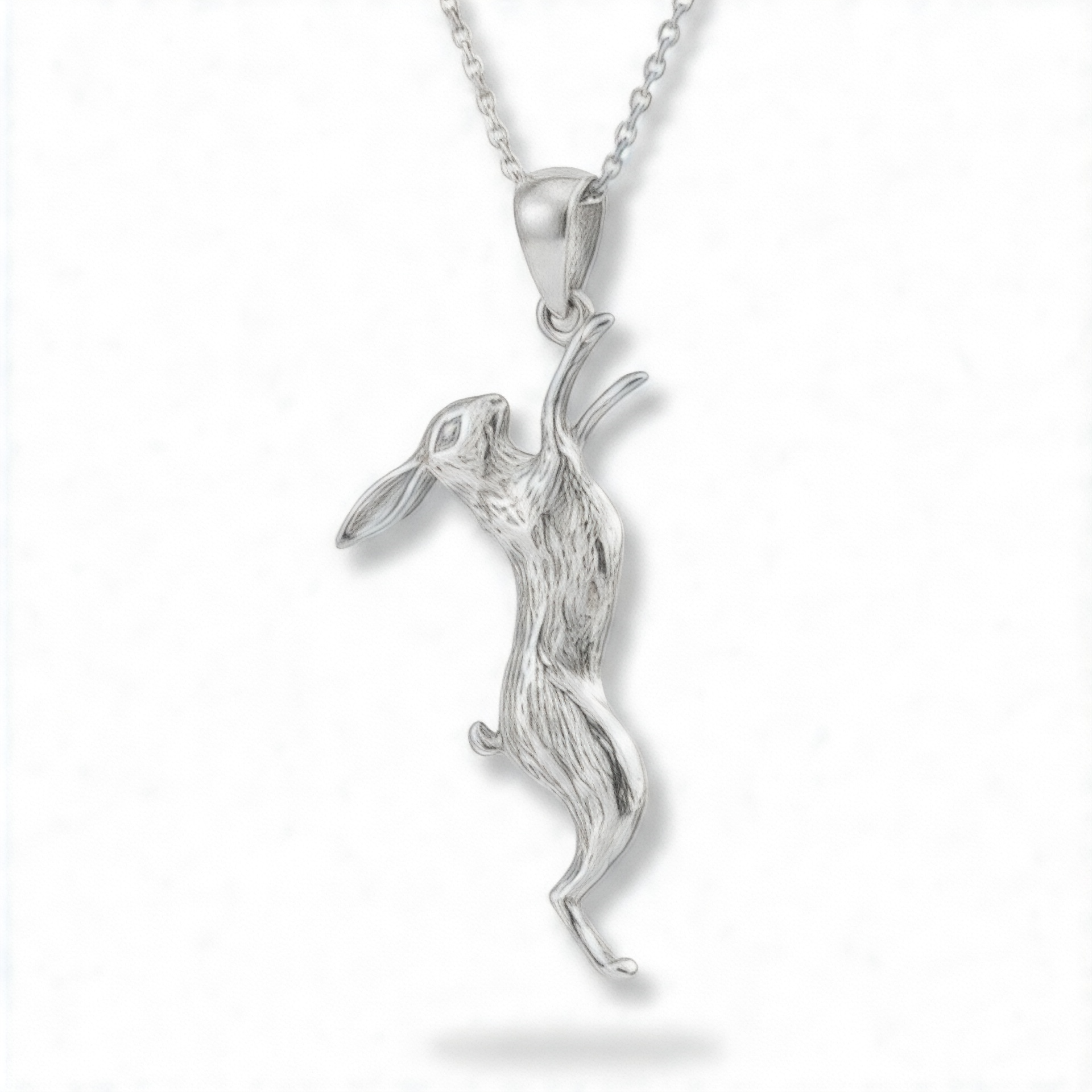 Handmade sterling silver March hare pendant necklace on a fine silver chain against a white background