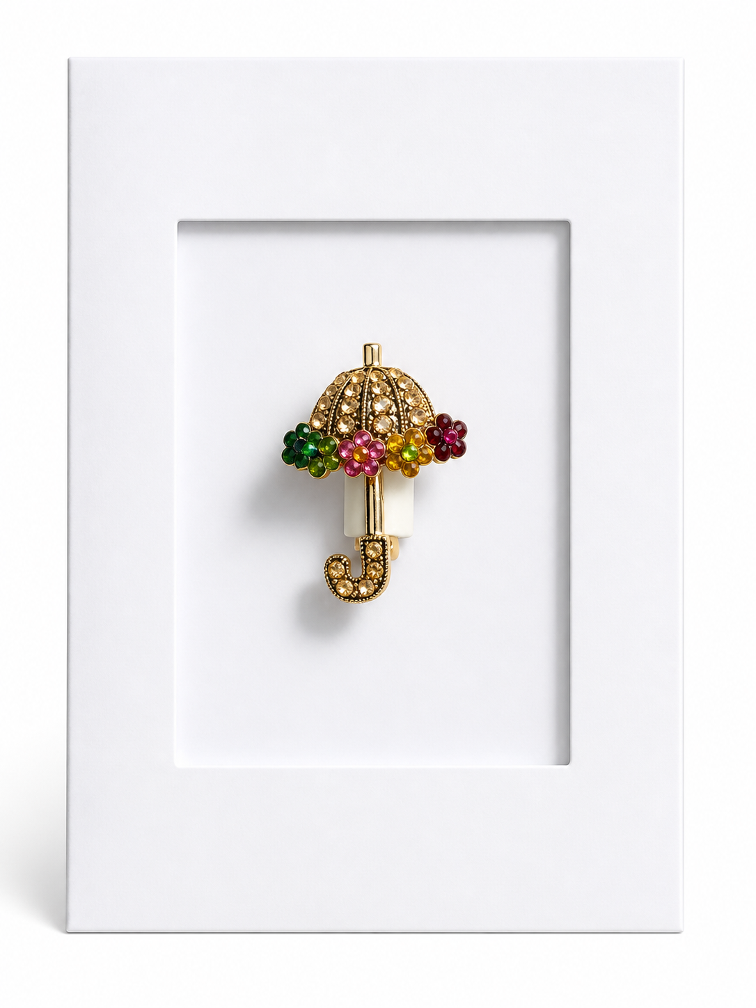 Decorative umbrella keepsake card featuring a sparkling umbrella brooch mounted within a white presentation card.