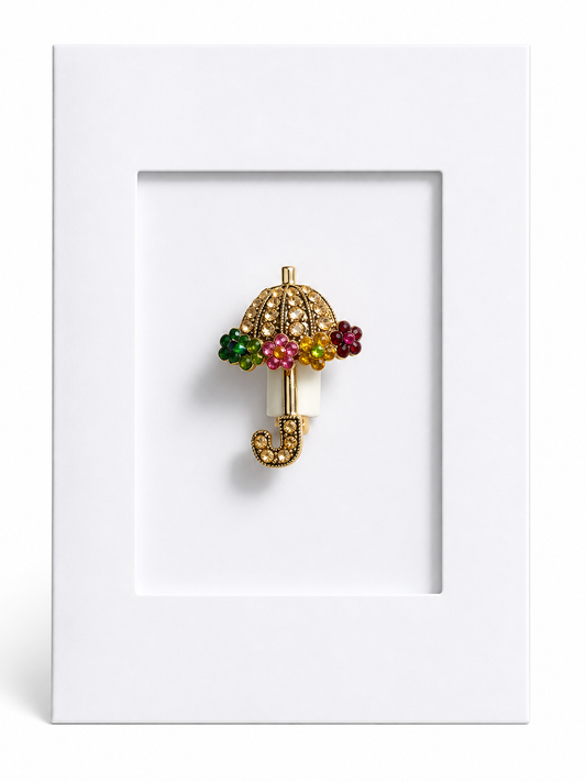 Decorative umbrella keepsake card featuring a sparkling umbrella brooch mounted within a white presentation card.
