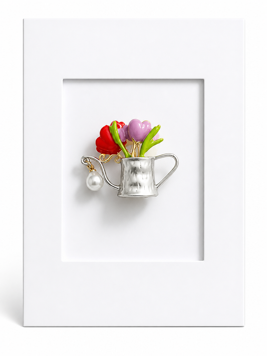 Floral keepsake card featuring a silver watering can brooch with colourful flowers mounted within a white presentation card.