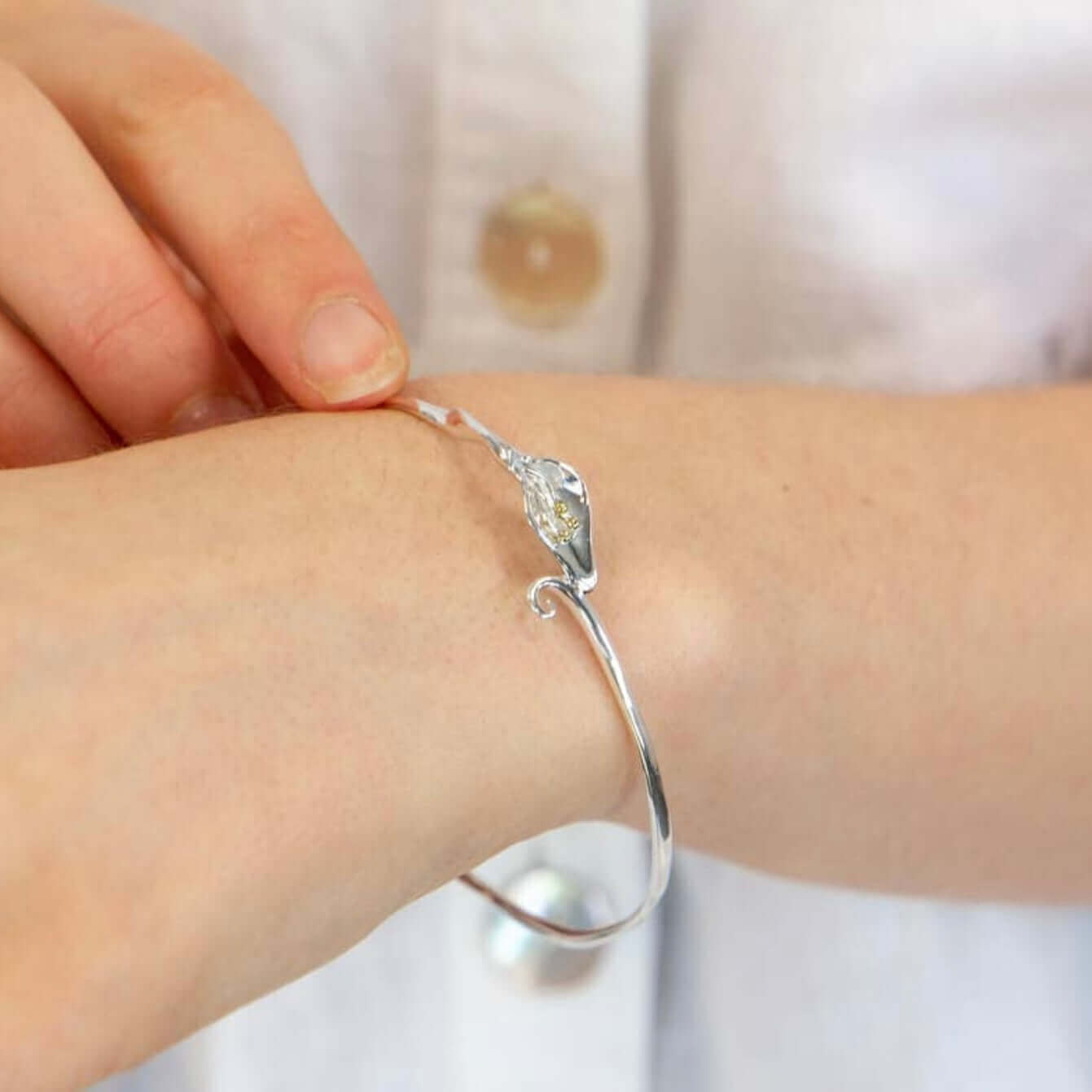 Front view of handcrafted Calla Lily floral bangle in sterling silver with gold detailing - Twelve Silver Trees