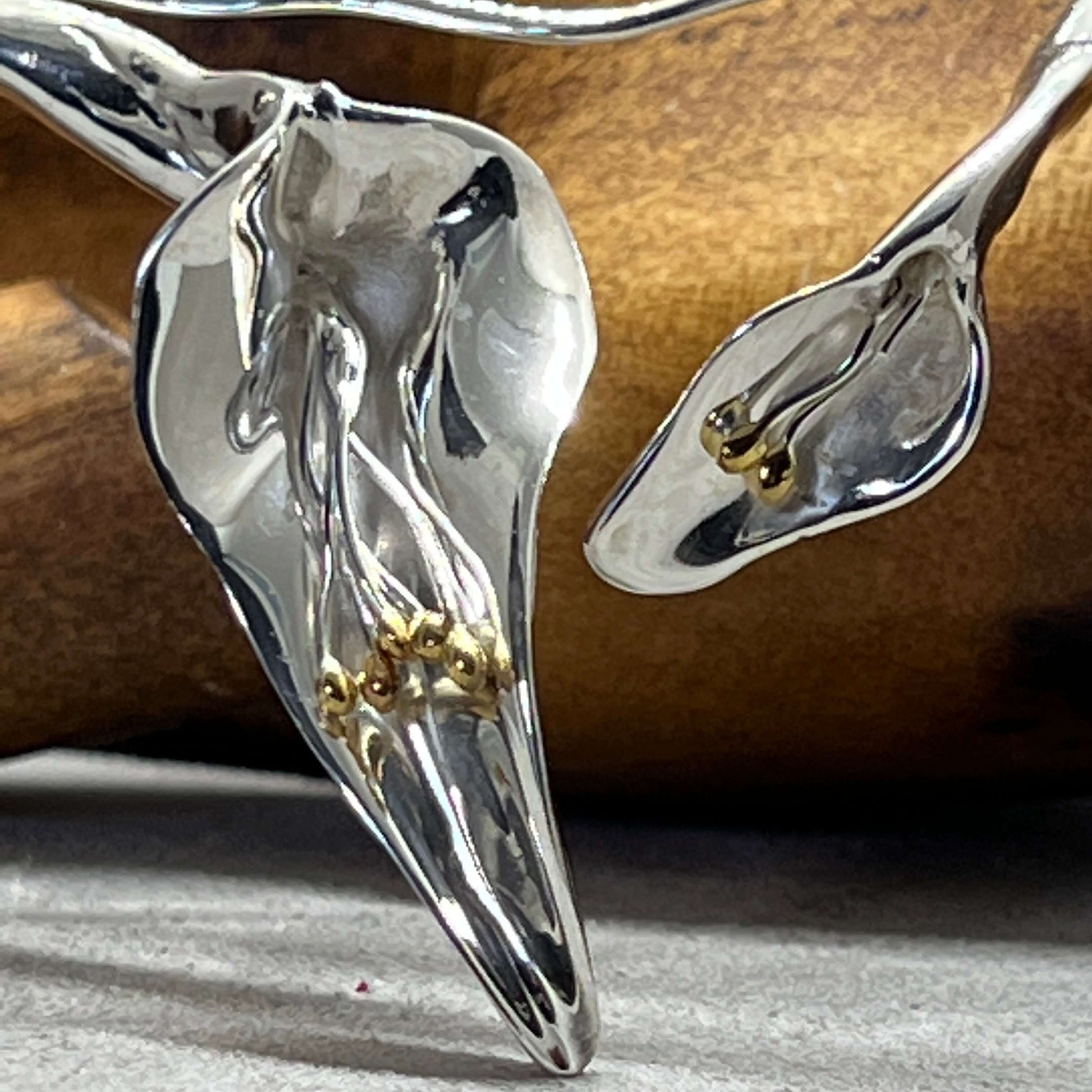 Close-up of handcrafted Calla Lily statement necklace in sterling silver with delicate gold stamens - Twelve Silver Trees